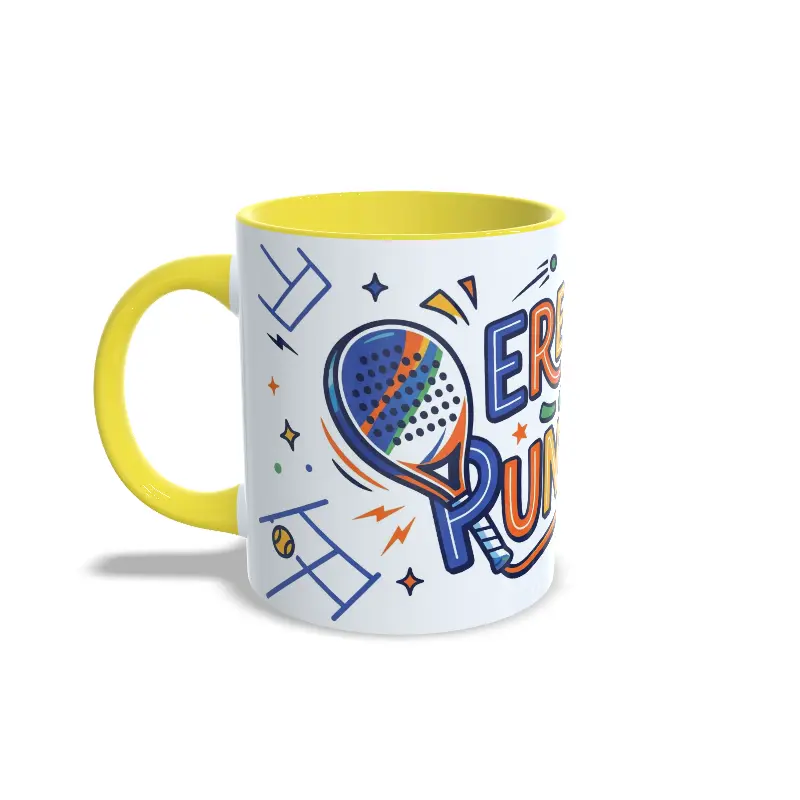 Taza de cerámica sobre pádel con diseño ilustrado de pala y texto Eres un puntazo, interior y asa en color amarillo, vista lateral izquierda.
