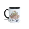 Taza de cerámica sobre pintura y arte con ilustración de caballete, paleta, taza de café y frase In My Office, interior y asa en color negro, vista lateral izquierda.
